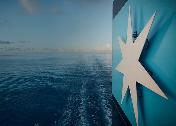 Maersk logo displayed on a ship in the ocean.