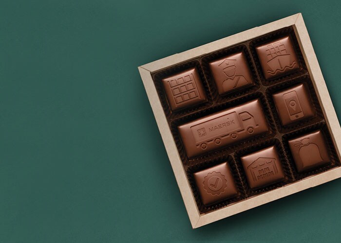 Maersk’s integrated logistics solutions across ocean and land engraved on chocolate placed in a box.