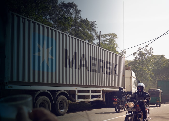 Maersk container attached to a truck on a road