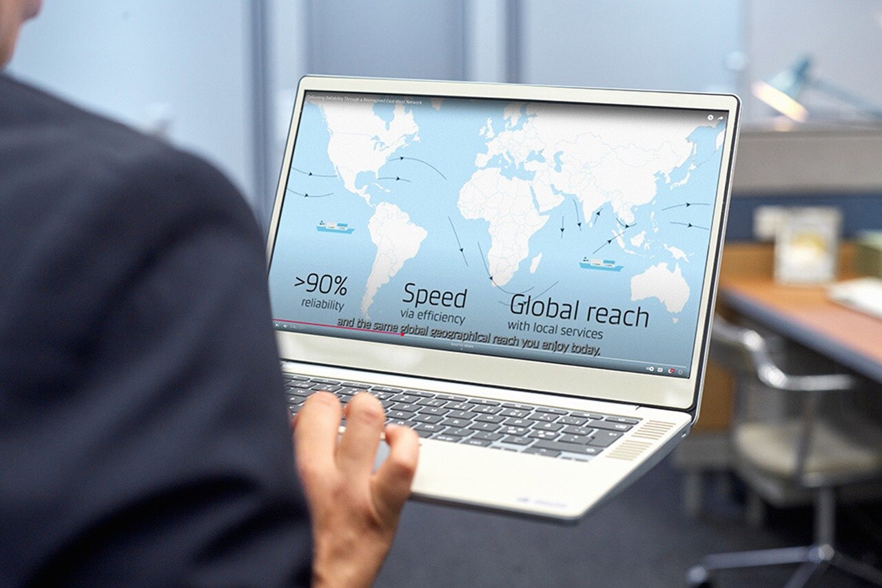 Person holding a laptop displaying a global shipping map with text highlighting 90% reliability, speed, and global reach