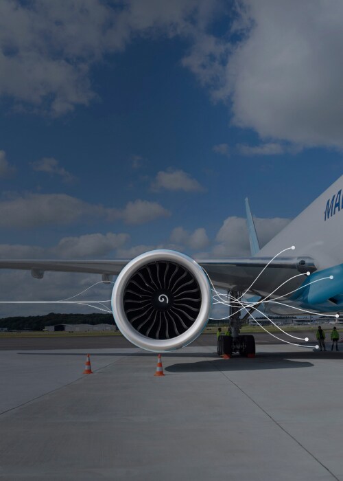 Maersk Air Cargo aircraft on the tarmac, focusing on a jet engine with digital flow lines overlayed