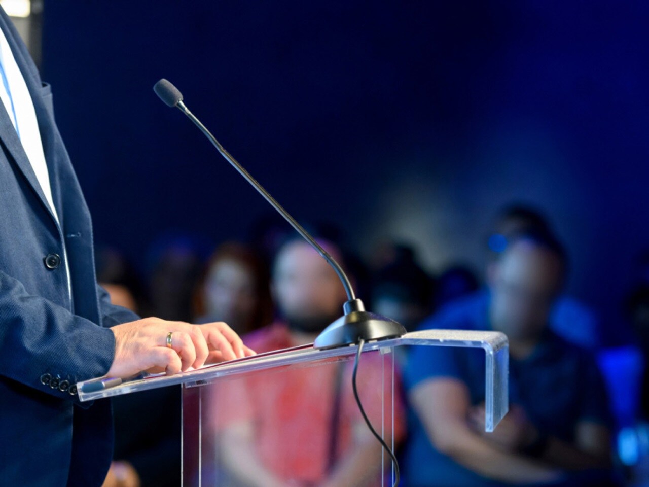 Speaker standing at podium with microphone