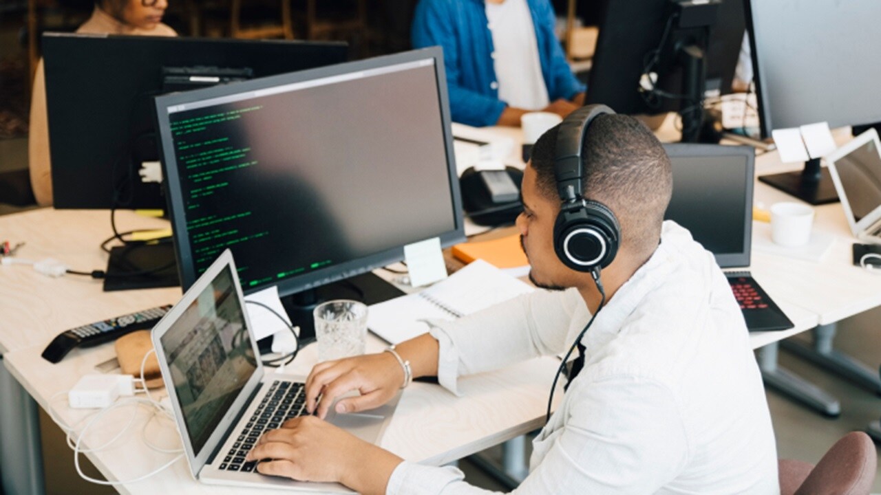 Man in work station with laptop