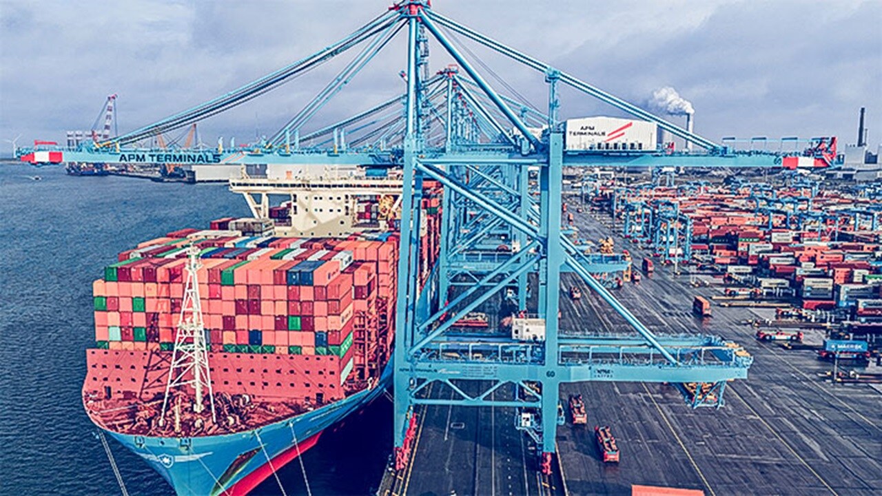 Large container vessel docked at a busy terminal