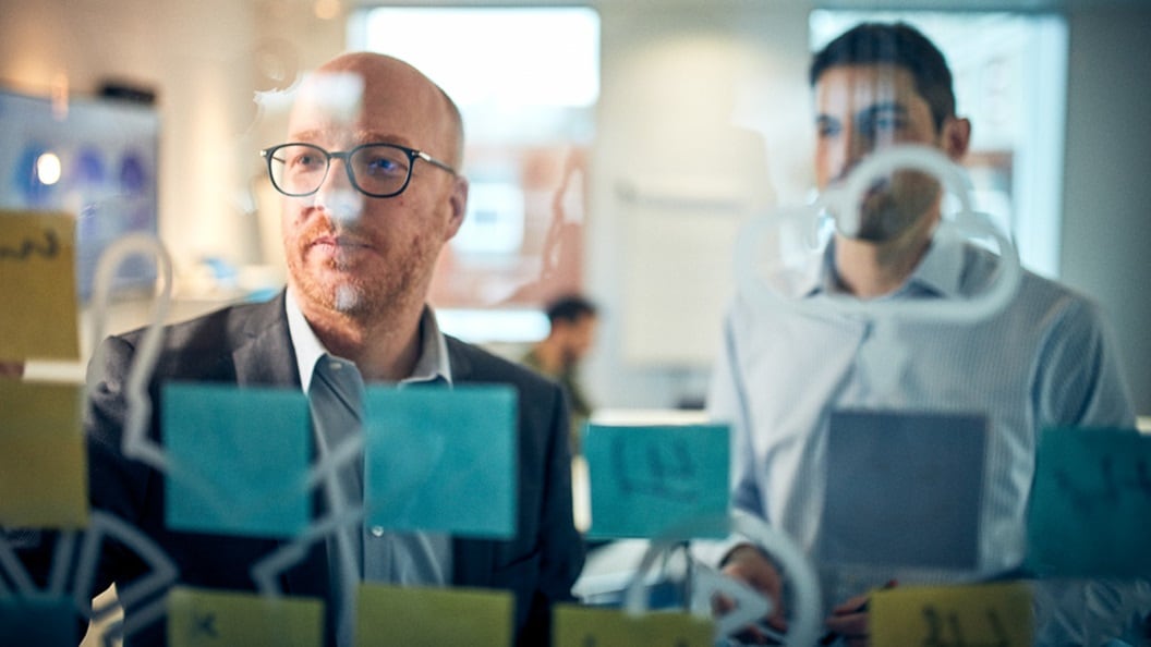 Two employees working together in an office space.
