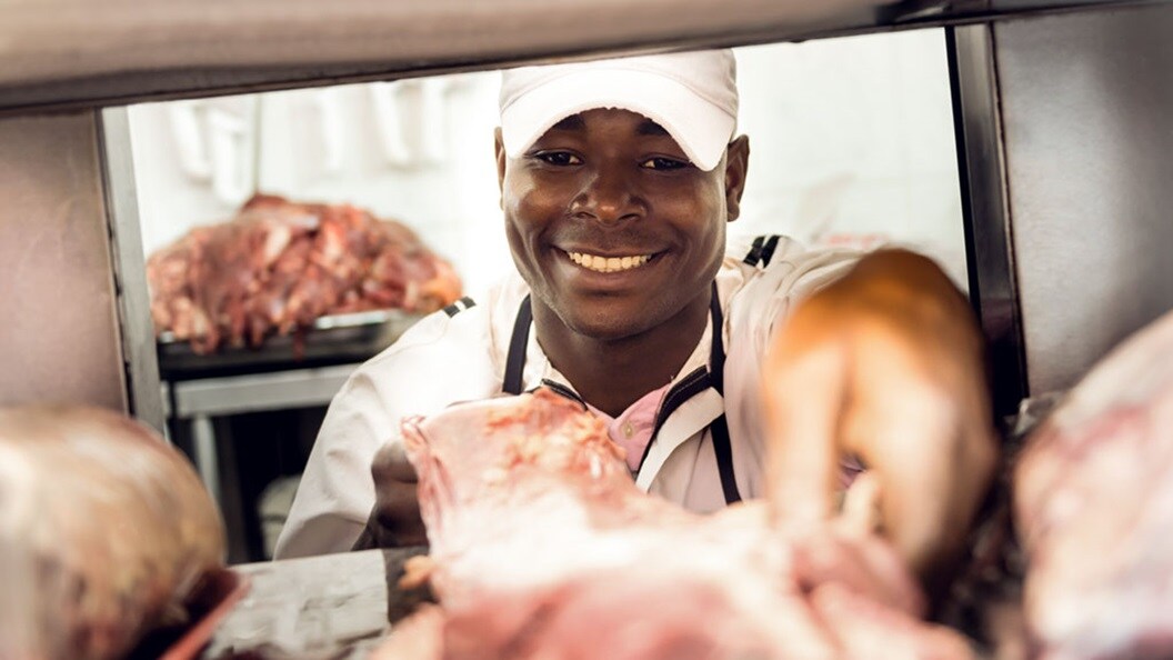 Butcher holding meat