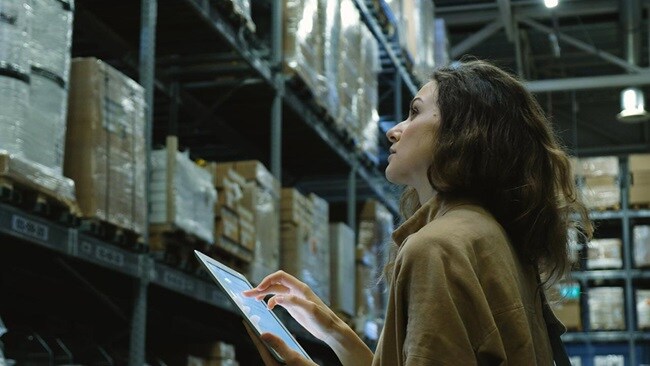 Woman checking stock levels in warehouse