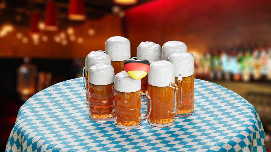 Oktoberfest steins of beer on top of table.