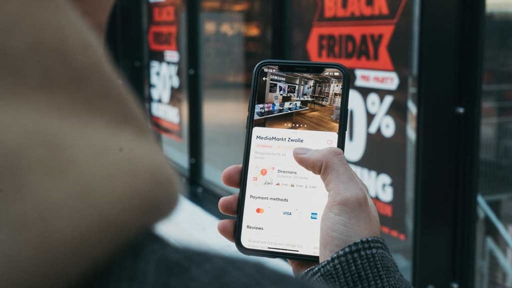 man holding a phone doing online shopping 