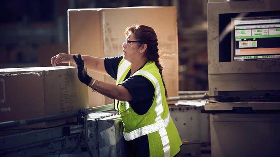 Woman in a warehouse dispatching returns product