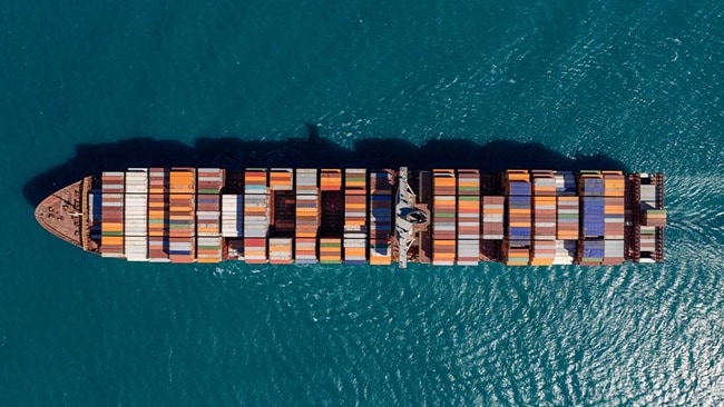 A container ship crossing the sea seeing from above
