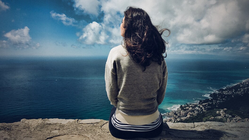 A person in a hard hat looks out to see representing the mission to reduce greenhouse gas emissions in shipping 
