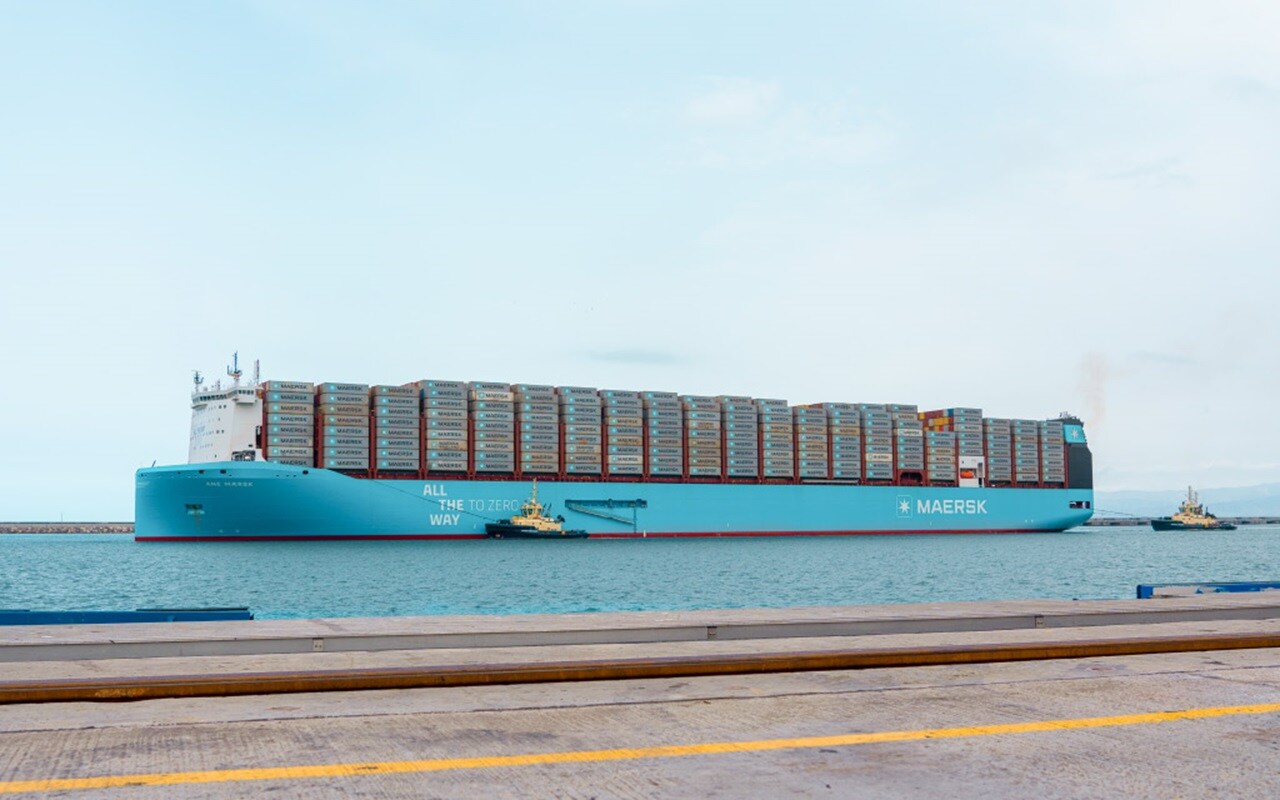 Maersk container ship docked at a port.