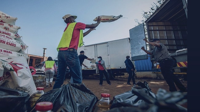 Agile logistics solutions – Men and women handling the relief cargo containing food and equipment.