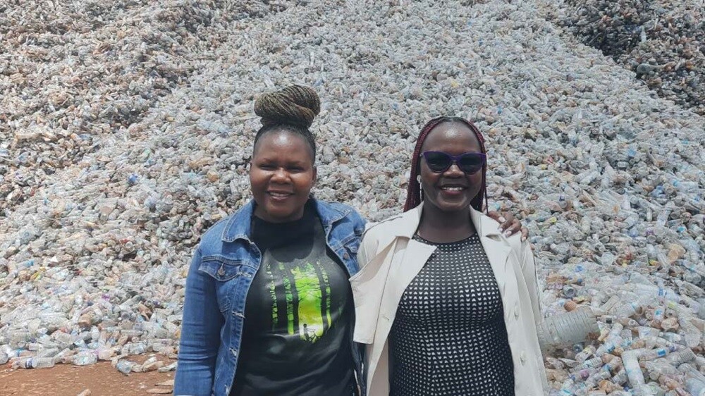 Two person posing before plastic recycling