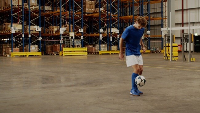 A male juggling with a football