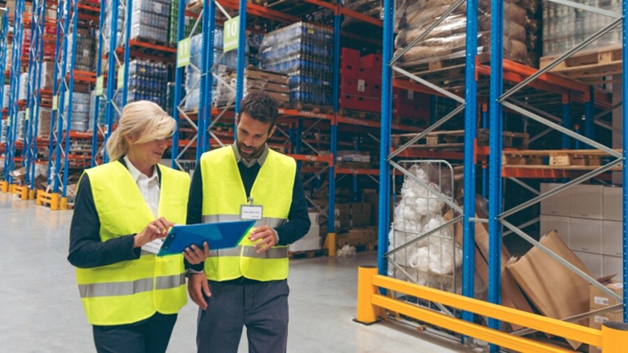 A male and a female conversing in a dockyard