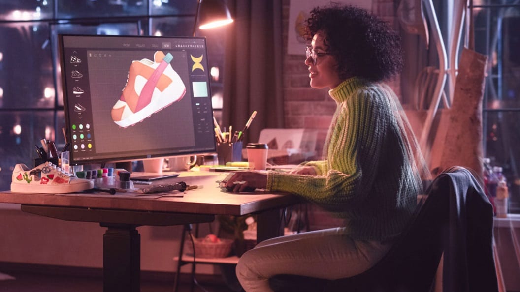 Women designing shoe in desktop.