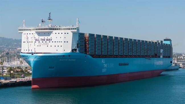 Maersk's new container ship, the largest in the world, is showcased in a port setting, highlighting its impressive size.