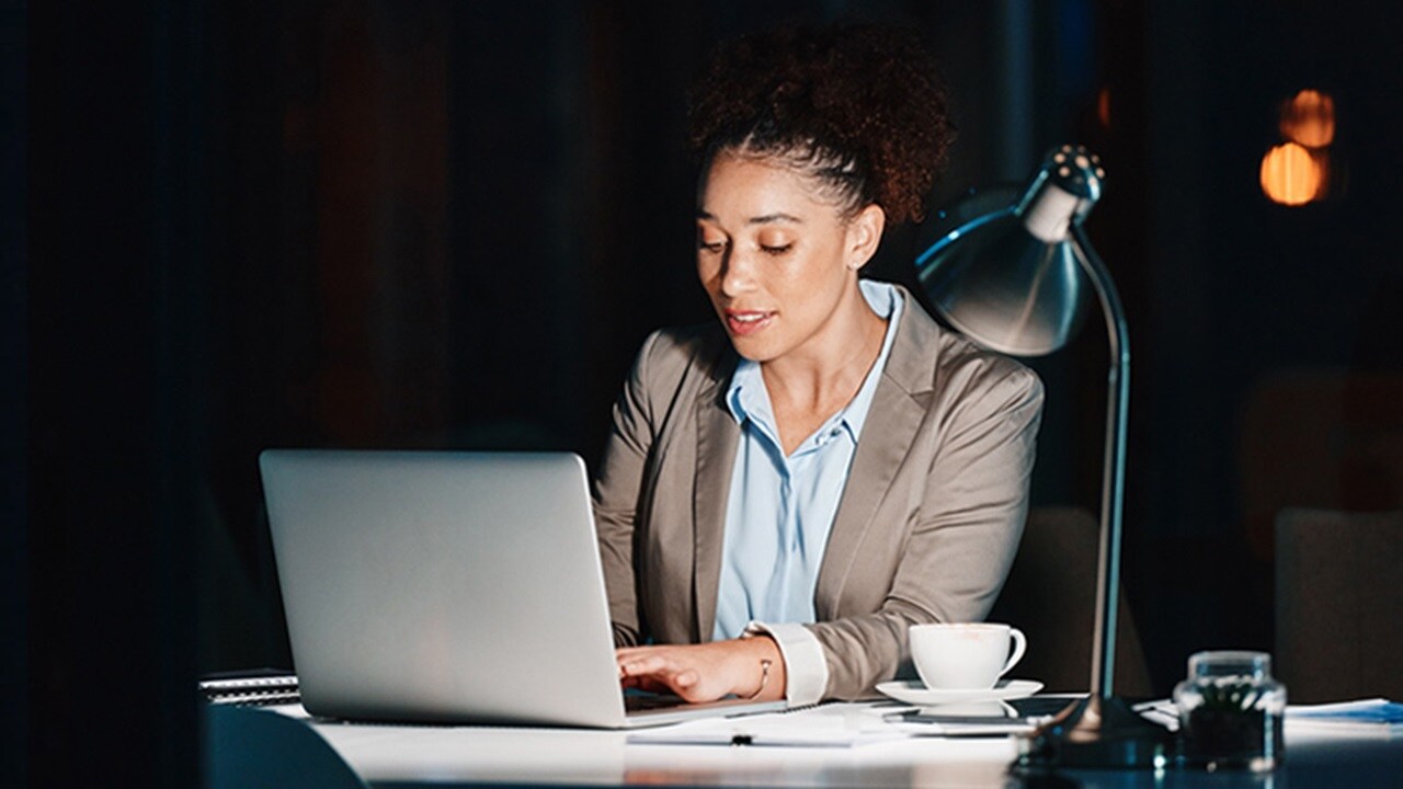 A young woman using their laptop to explore EDI solutions.