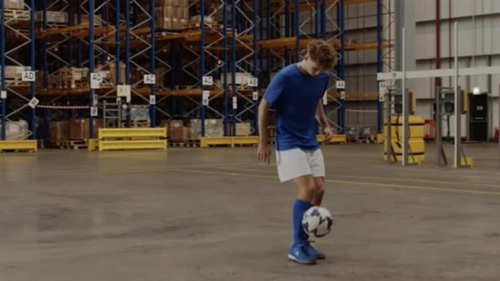 A male juggling with a football