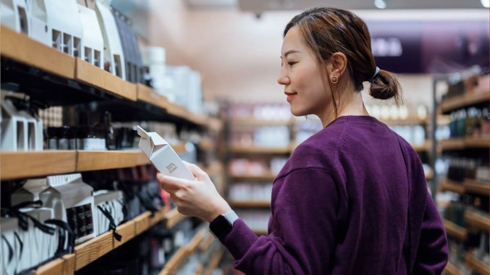 Woman choosing from a range of products in a department store.