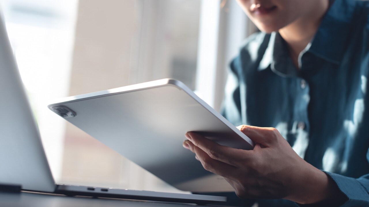 A set of hands holding a tablet