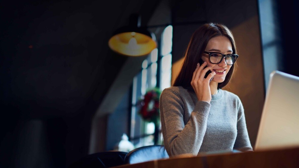 Woman on a phone call with the Maersk Destination Coordination Services team in front of a laptop.