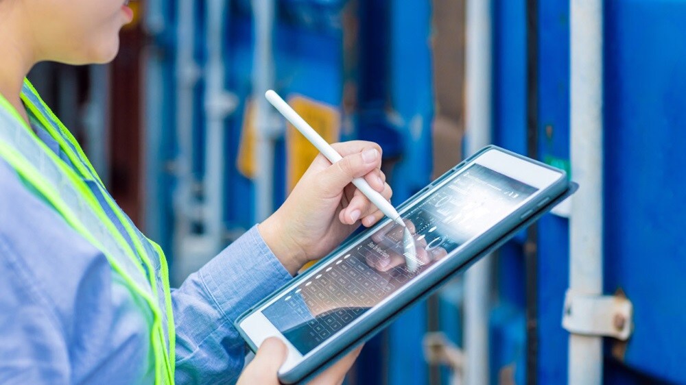 Port staff monitoring shipment information on a tablet