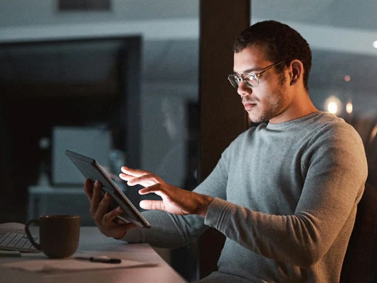 A man is checking on how to apply for an ECTN certificate using a digital tab.