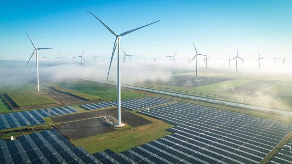 Wind turbines and solar panels generating renewable energy at a modern farm.