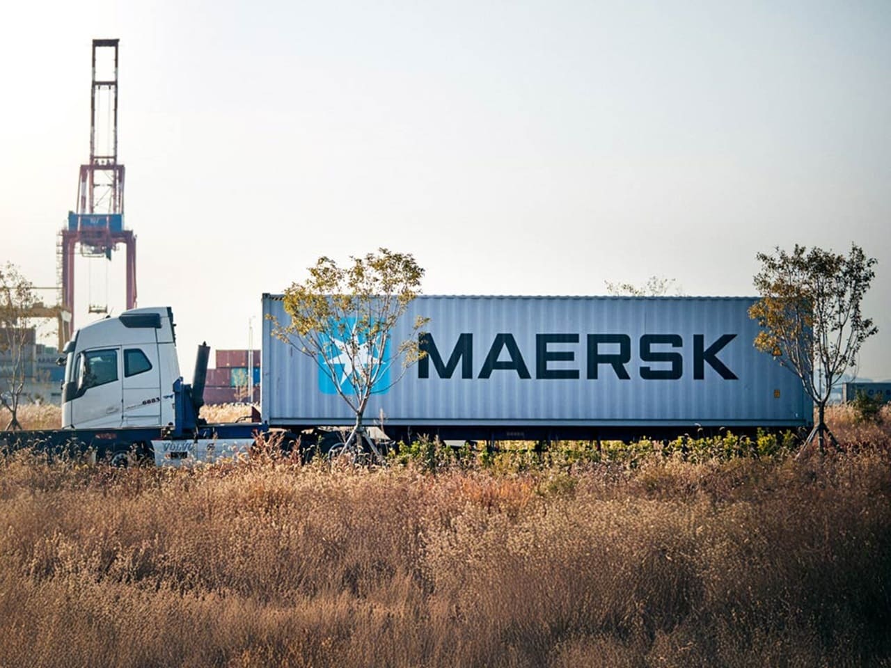 Maersk container truck near port terminal, showcasing intermodal logistics and efficient inland transportation