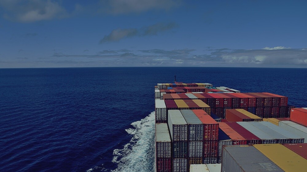 A cargo ship transporting containers across the ocean.